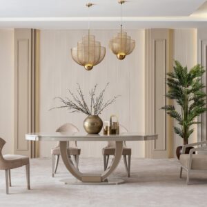 Sophisticated dining room featuring the cream Lusso dining set with a bronze-accented oval table, plush chairs, and a matching sideboard, complemented by golden decor and modern pendant lighting, in a neutral-toned interior.