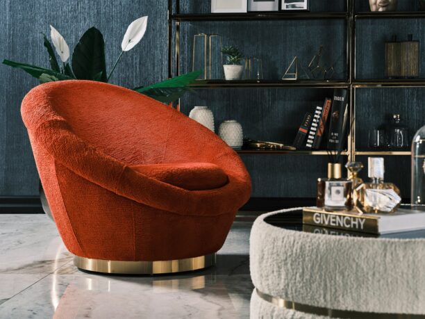 Miami Armchair featuring bold curves, plush orange bouclé upholstery, and a gold circular base, perfect for contemporary luxury interiors.