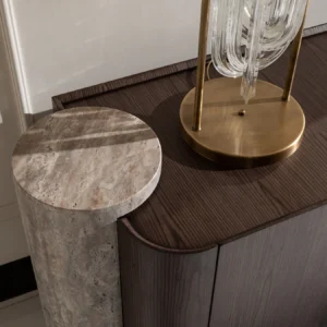 Palermo sideboard with dark wood veneer, travertine stone pillar, and brushed gold base; paired with a round led mirror.