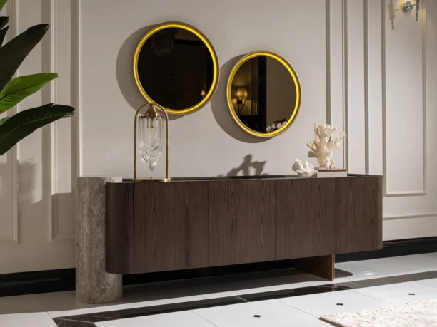 Palermo sideboard with dark wood veneer, travertine stone pillar, and brushed gold base; paired with a round led mirror.