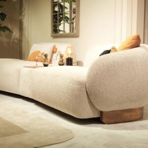 Amalfi corner chaise sofa in a luxurious neutral fabric with optional built-in wooden table, accented with plush cushions and modern Italian-inspired design, set in a contemporary living room