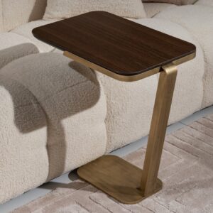 Genoa coffee table with a walnut wood finish and brushed gold accent details, displayed in a modern living room setting with a matching accent table and decorative items.