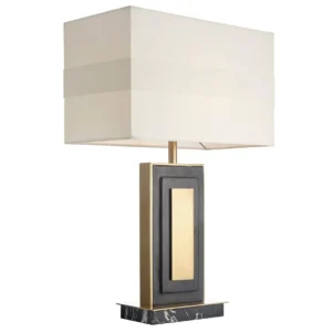 The Belmont Table Lamp is a captivating piece that blends modern sophistication with luxurious materials. Featuring a bold rectangular base crafted from black marble, it is accented with antique brass and sleek black panels for a striking geometric design. This architectural silhouette is complemented by a clean, rectangular fabric shade, which diffuses light beautifully, creating a warm and inviting glow.