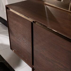 Front view of the Dakota Sideboard with dark wood veneer finish and brushed gold trims, styled with elegant décor.