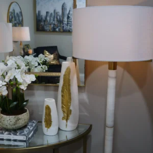 Luxury marble and gold floor lamp with fabric drum shade. Modern tall floor lamp with brushed gold accents and smooth white marble column. Elegant lighting for living rooms, bedrooms, and hallways