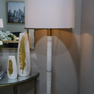 Luxury marble and gold floor lamp with fabric drum shade. Modern tall floor lamp with brushed gold accents and smooth white marble column. Elegant lighting for living rooms, bedrooms, and hallways