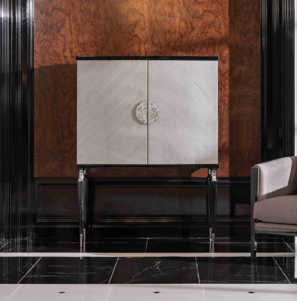 The Venetian Storage Cabinet features a curved design, silver textured panels, and elegant black and gold legs for a sophisticated touch.