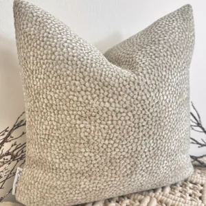 The Oatmeal Bouclé Cushion brings a touch of understated luxury with its plush velvet-bouclé texture and warm neutral tone. Its rich fabric adds depth and warmth, making it a perfect accent for any interior.