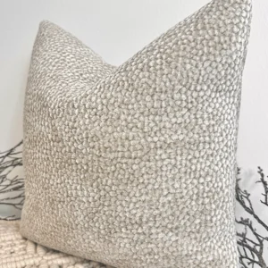 The Oatmeal Bouclé Cushion brings a touch of understated luxury with its plush velvet-bouclé texture and warm neutral tone. Its rich fabric adds depth and warmth, making it a perfect accent for any interior.