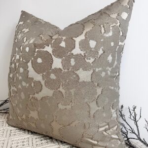 The Aurora Textured Taupe Cushion blends timeless elegance with modern texture. Featuring a rich taupe base with shimmering gold flecks woven throughout, it adds depth and sophistication to any space. The intricate fabric design creates a beautiful contrast of matte and sheen, making it a true statement piece. This luxurious cushion is available in various sizes and can be made to order with your choice of 100% duck feather or polyester inserts. Designed with an invisible zip fastening for a seamless finish, it’s perfect for layering on sofas, beds, or accent chairs.